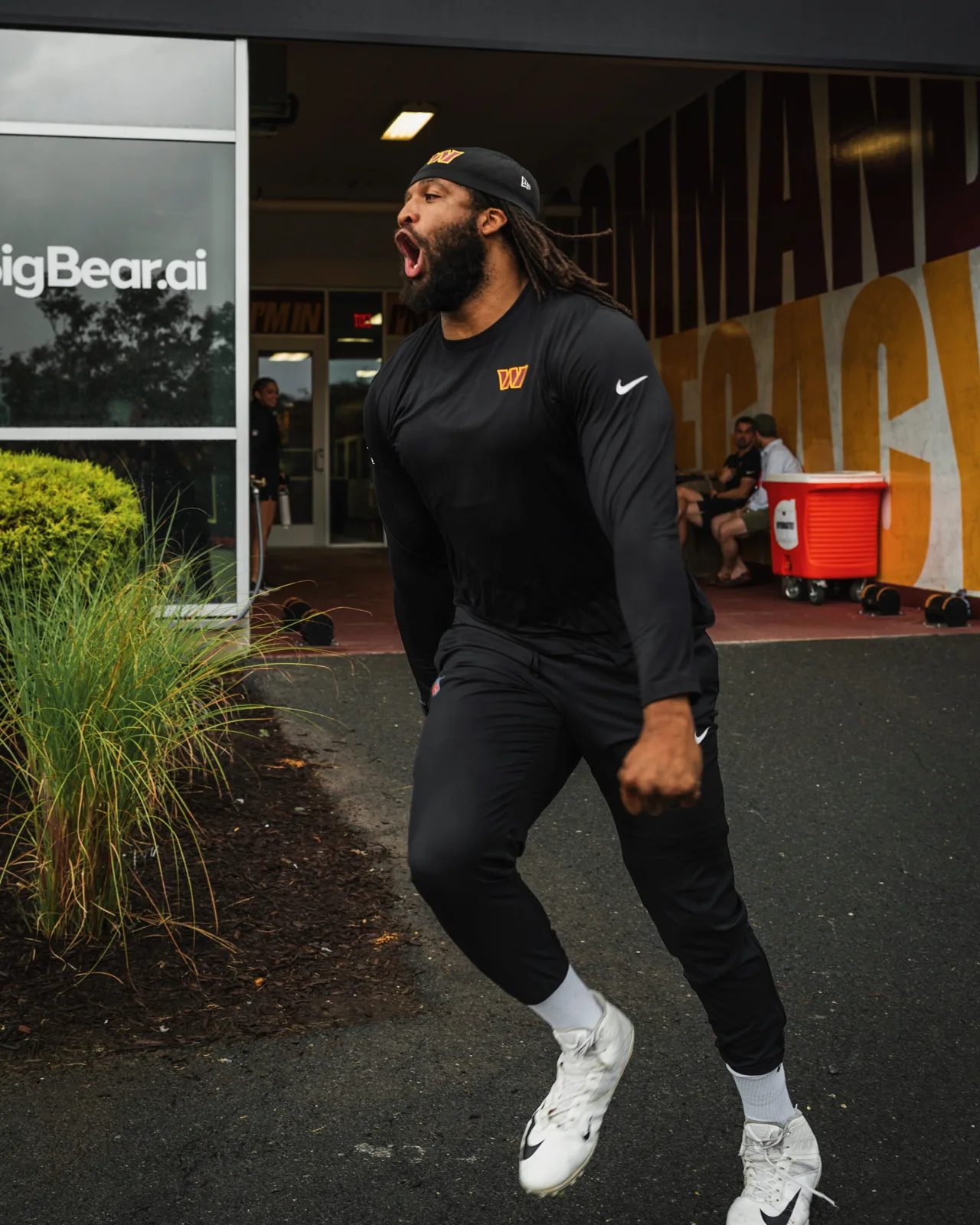 Deatrich Wise Jr. walking with Washington Commanders teammates