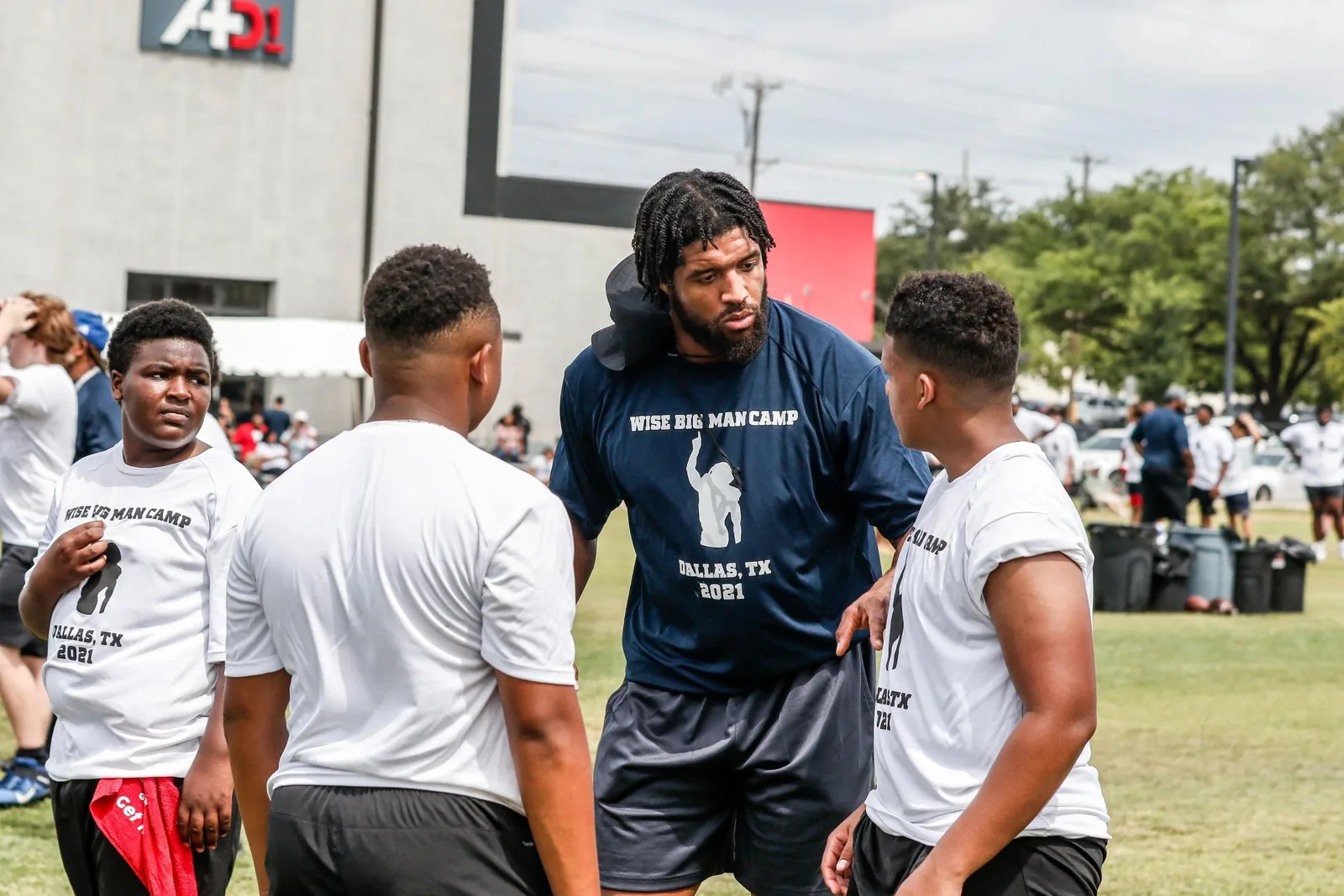Linemen in a huddle at the WISE Big Man Camp